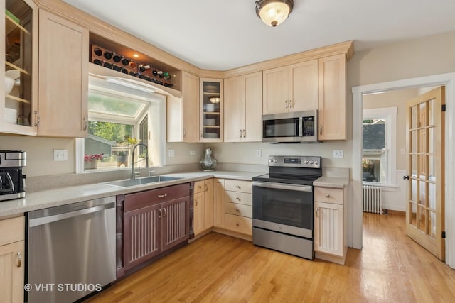 406 S Evergreen Ave, Arlington Heights, IL 60005 - kitchen featuring appliances with stainless steel finishes, radiator, light brown cabinets, a sink, and light countertops