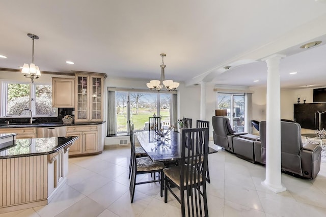dining room featuring decorative columns, recessed lighting, light tile patterned floors, and a chandelier