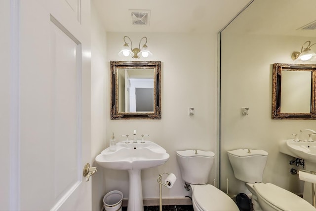 bathroom featuring visible vents and toilet