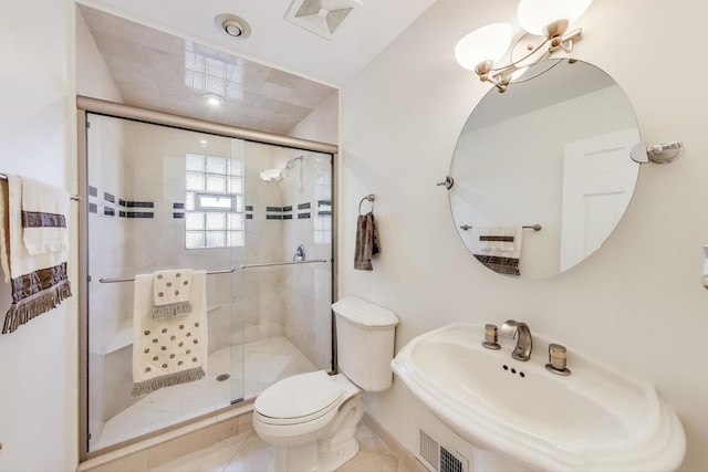 bathroom featuring a shower stall, a sink, visible vents, and toilet