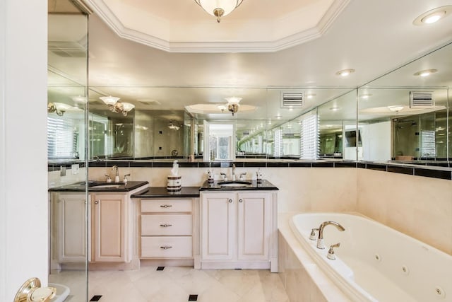 full bathroom with a whirlpool tub, visible vents, a sink, and crown molding
