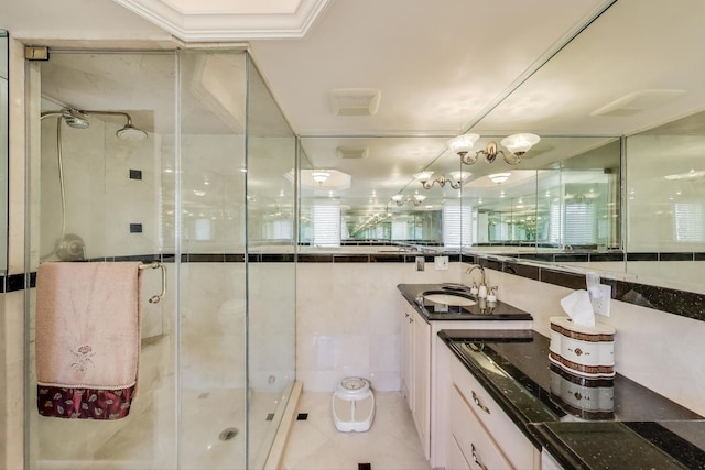 bathroom with a shower stall and vanity