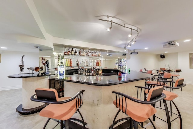 bar featuring wet bar and baseboards
