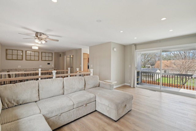 living room featuring recessed lighting, ceiling fan, baseboards, and light wood-style flooring