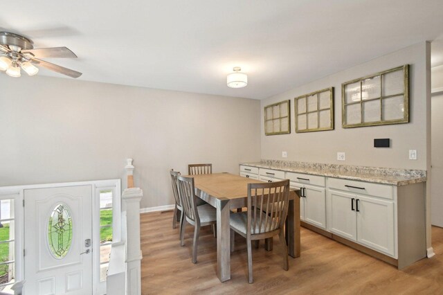 dining space with light wood-style flooring and a ceiling fan