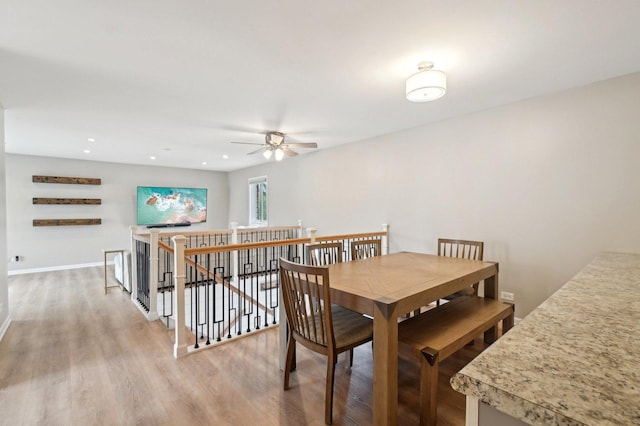 dining room featuring ceiling fan, baseboards, light wood-style floors, and recessed lighting