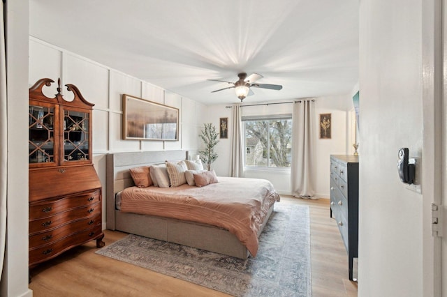 bedroom with a ceiling fan and light wood-style flooring