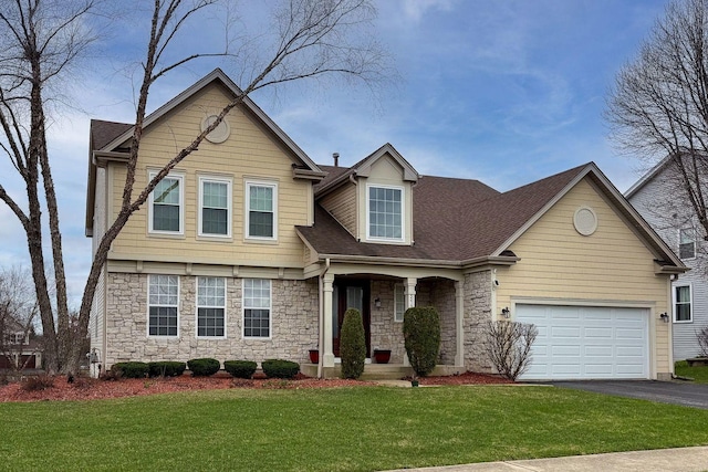 view of front facade featuring roof with shingles, aphalt driveway, stone siding, and a front lawn