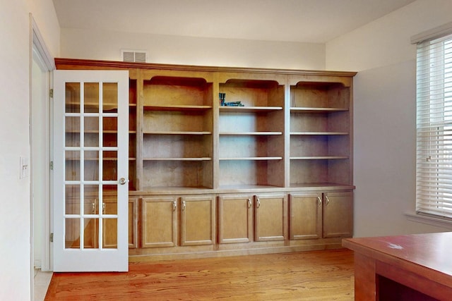 unfurnished office with light wood-type flooring and visible vents