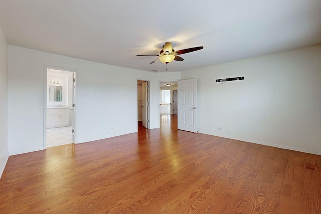 empty room featuring a ceiling fan and wood finished floors