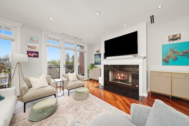 2041 W Division St Unit 304, Chicago, IL 60622 - living area featuring a tiled fireplace, wood finished floors, and a wealth of natural light