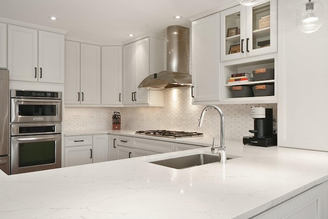2041 W Division St Unit 304, Chicago, IL 60622 - kitchen featuring wall chimney range hood, light stone countertops, double oven, white cabinetry, and backsplash