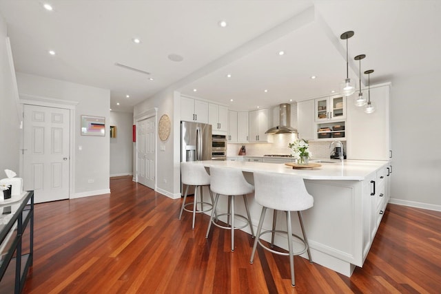 2041 W Division St Unit 304, Chicago, IL 60622 - kitchen with light countertops, wall chimney exhaust hood, white cabinets, a sink, and backsplash