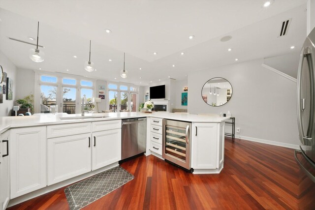 2041 W Division St Unit 304, Chicago, IL 60622 - kitchen featuring dark wood finished floors, appliances with stainless steel finishes, a sink, and wine cooler