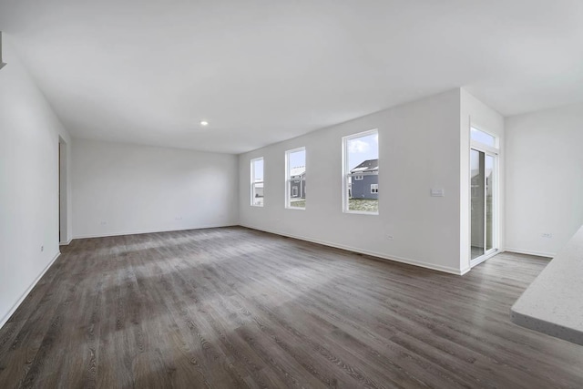 9948 Central Park Blvd, Huntley, IL 60142 - unfurnished living room featuring dark wood-type flooring and baseboards