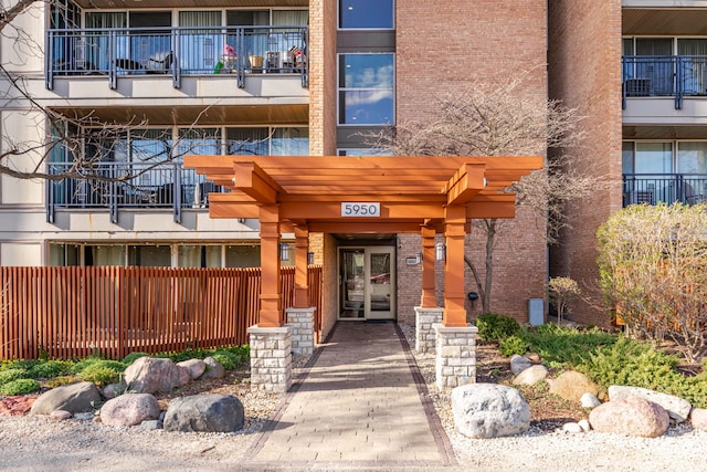 view of exterior entry with brick siding