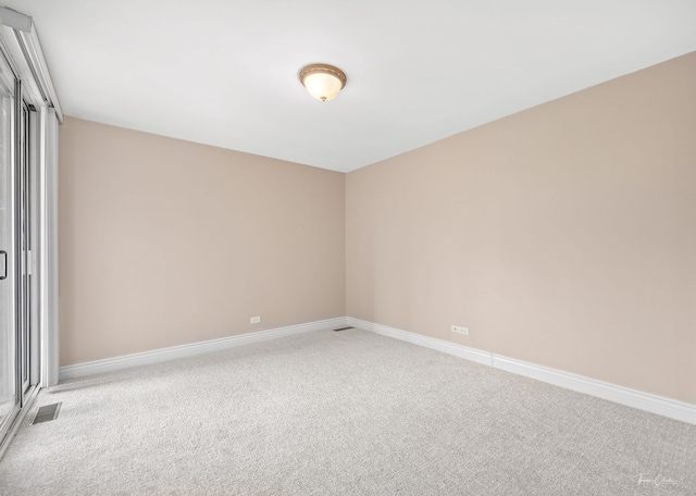 unfurnished room featuring visible vents, baseboards, and carpet floors