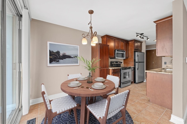 dining space with visible vents, baseboards, an inviting chandelier, and light tile patterned floors