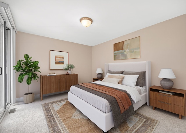 bedroom with visible vents and light carpet