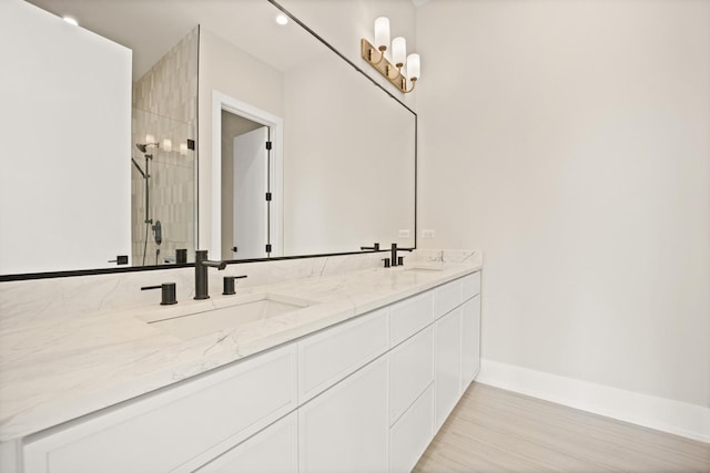 4347 N Richmond Ave Unit 3N, Chicago, IL 60618 - bathroom with double vanity, a stall shower, baseboards, and wood finished floors