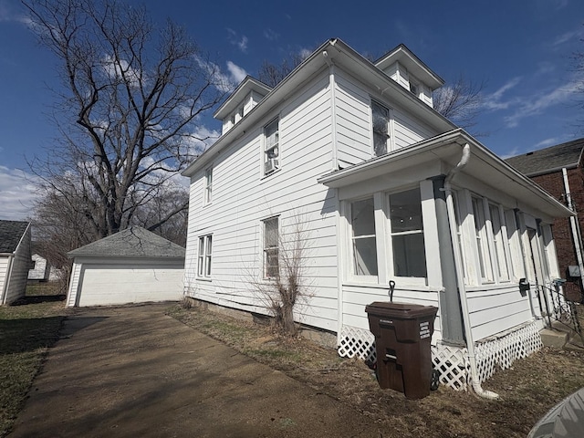 view of home's exterior featuring an outbuilding and a garage