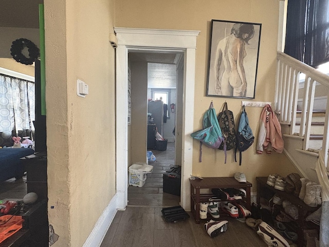 interior space with baseboards and wood finished floors