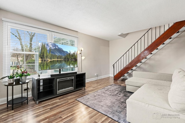 1290 Pleasant Ave Unit C, Glendale Heights, IL 60139 - living area featuring baseboards, a textured ceiling, wood finished floors, and stairs