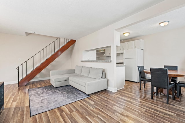 1290 Pleasant Ave Unit C, Glendale Heights, IL 60139 - living room featuring wood finished floors, baseboards, and stairway