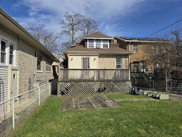 back of house with fence, a wooden deck, a lawn, and roof with shingles