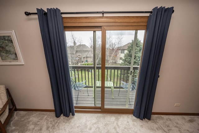 entryway featuring baseboards and carpet flooring