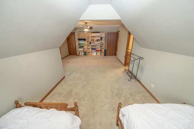 bedroom featuring baseboards, light carpet, and lofted ceiling