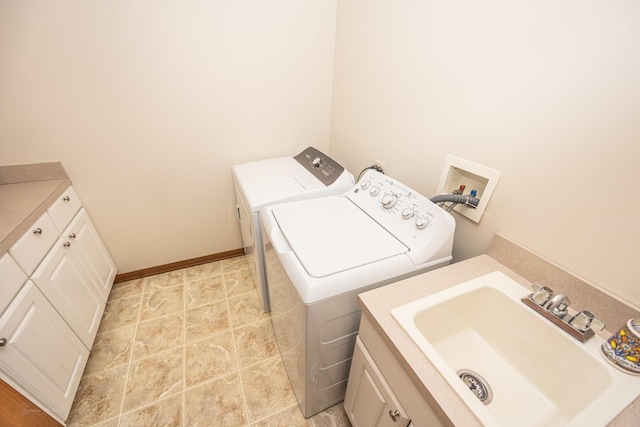 laundry area featuring a sink, baseboards, and washer and clothes dryer