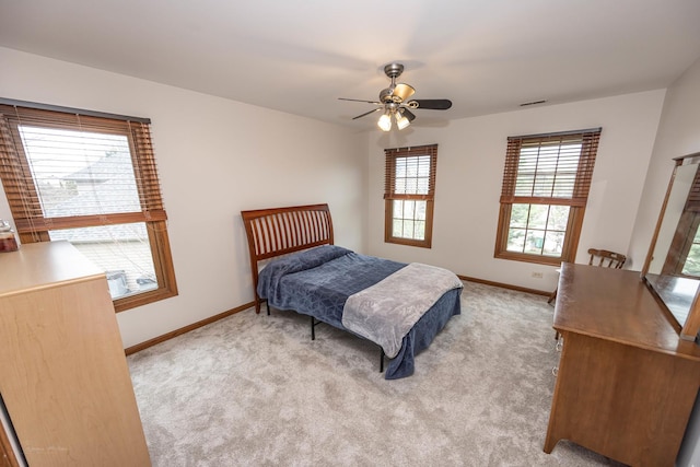 bedroom featuring ceiling fan, light colored carpet, baseboards, and visible vents