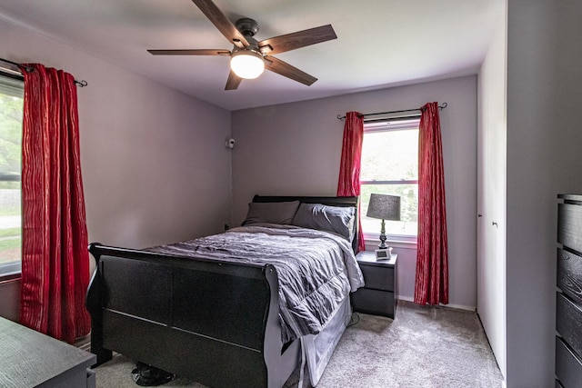 bedroom with carpet floors, a ceiling fan, and baseboards