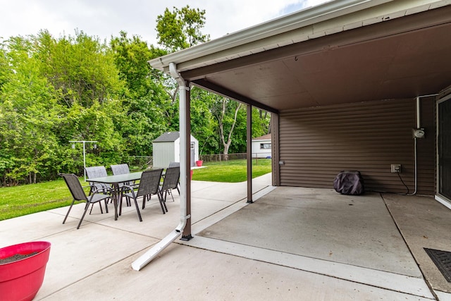 view of patio featuring a shed, outdoor dining space, and an outdoor structure