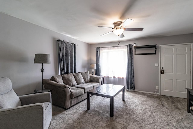 living area featuring ceiling fan, carpet flooring, and baseboards