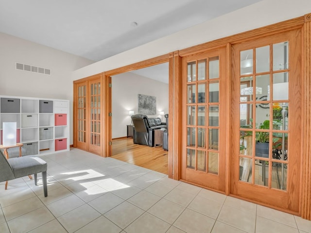 living area with french doors, tile patterned floors, and visible vents