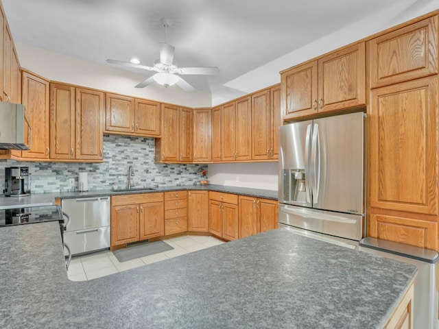 kitchen with ceiling fan, backsplash, a sink, stainless steel appliances, and light tile patterned flooring