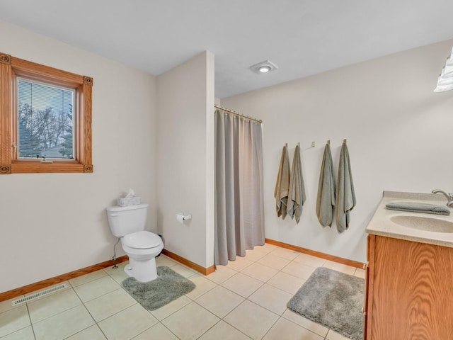 bathroom featuring visible vents, toilet, baseboards, tile patterned floors, and a sink