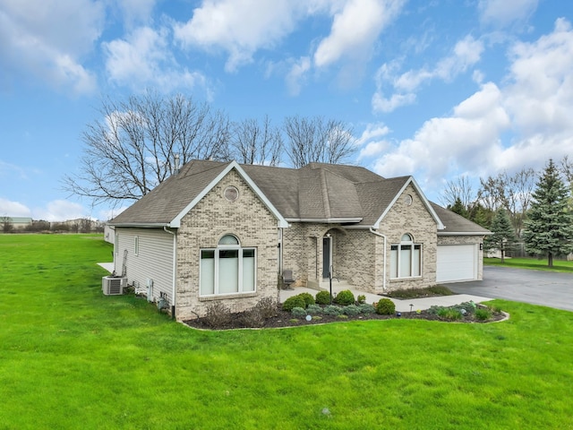 view of front facade with aphalt driveway, a front yard, brick siding, a shingled roof, and an attached garage