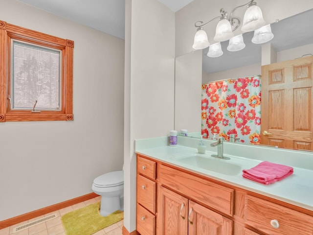 bathroom featuring visible vents, tile patterned flooring, vanity, baseboards, and toilet