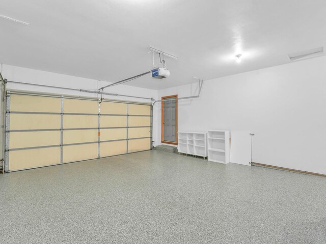 garage with baseboards and a garage door opener