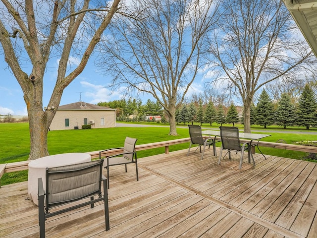 deck with a lawn and outdoor dining space