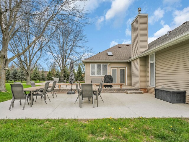 view of patio with outdoor dining area, french doors, and area for grilling