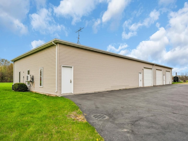view of home's exterior featuring a garage and a lawn