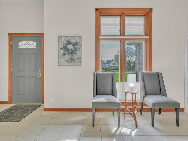 interior space with baseboards, tile patterned floors, and visible vents