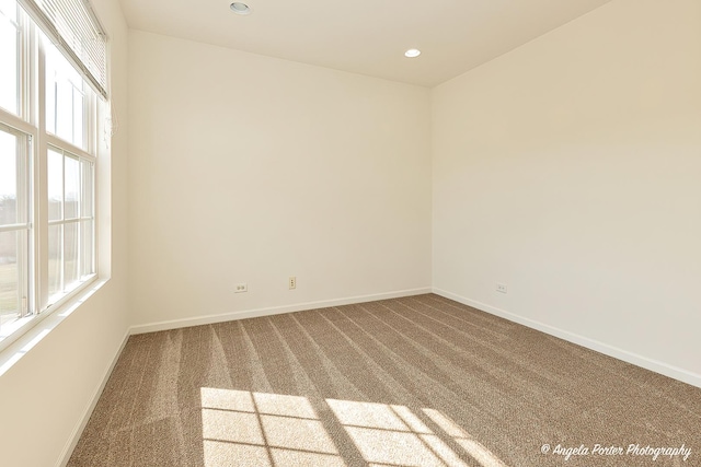empty room with a wealth of natural light, recessed lighting, carpet, and baseboards
