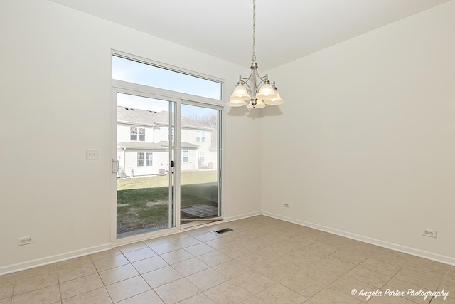 spare room featuring a chandelier, light tile patterned floors, baseboards, and visible vents