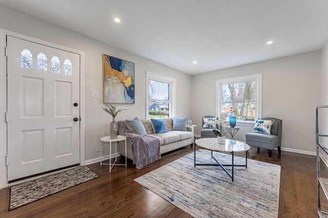 living area with recessed lighting, dark wood-style floors, and baseboards