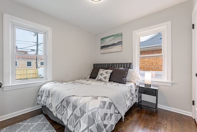 bedroom with baseboards and wood finished floors
